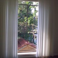 חלונות בלגיים בבית פרטי מאחורי וילון